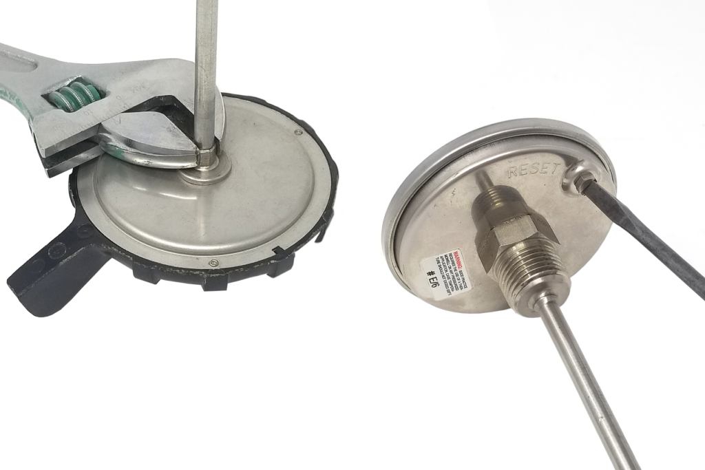 using a wrench for calibrating analogue dial thermometers