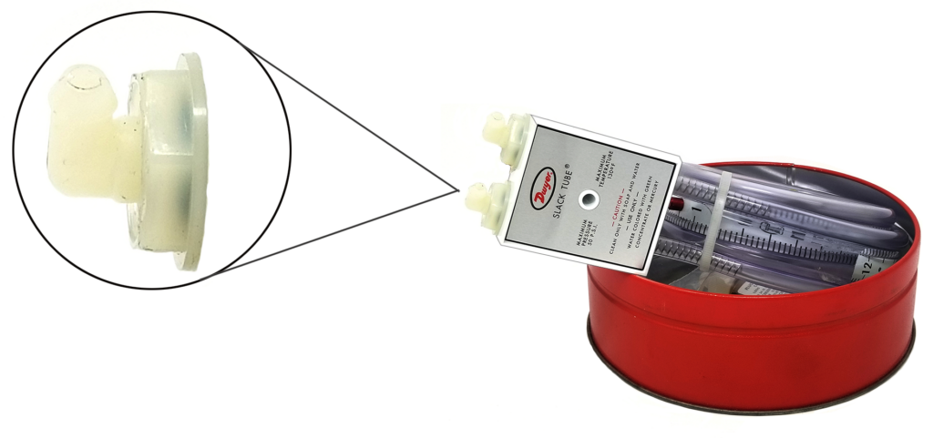 Image showing a Dwyer Slack Tube manometer in a red circular case, with an inset close-up of a plastic connector piece. The case contains the manometer tubing and accessories.