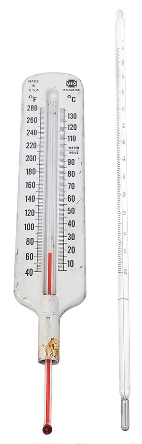 two glass stemmed thermometers